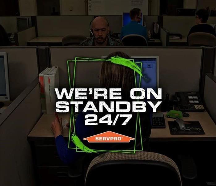 A call center is shown with the words we're standing by and an orange SERVPRO logo
